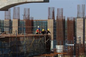 Labourers work at a construction site of a metro rail project in New Delhi.