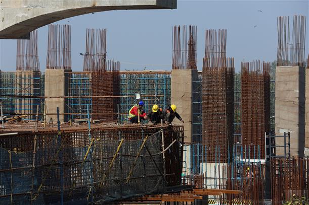 Labourers work at a construction site of a metro rail project in New Delhi.