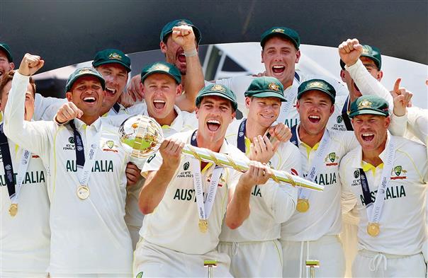 Australia’s players celebrate with the ICC Test Mace on the podium