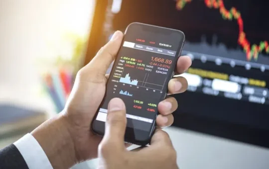 investor-analyzing-stock-market-investments-with-financial-dashboard-on-smartphone-and-computer-screens
