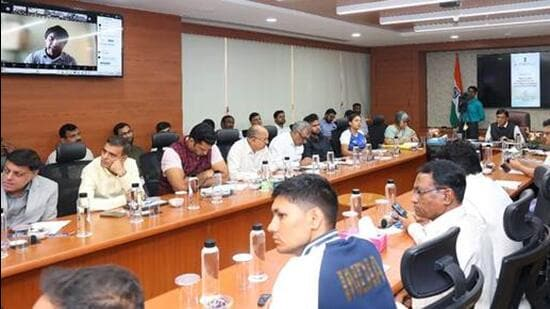 Athletes-and-coaches-during-a-consultation-meeting_1729703512092